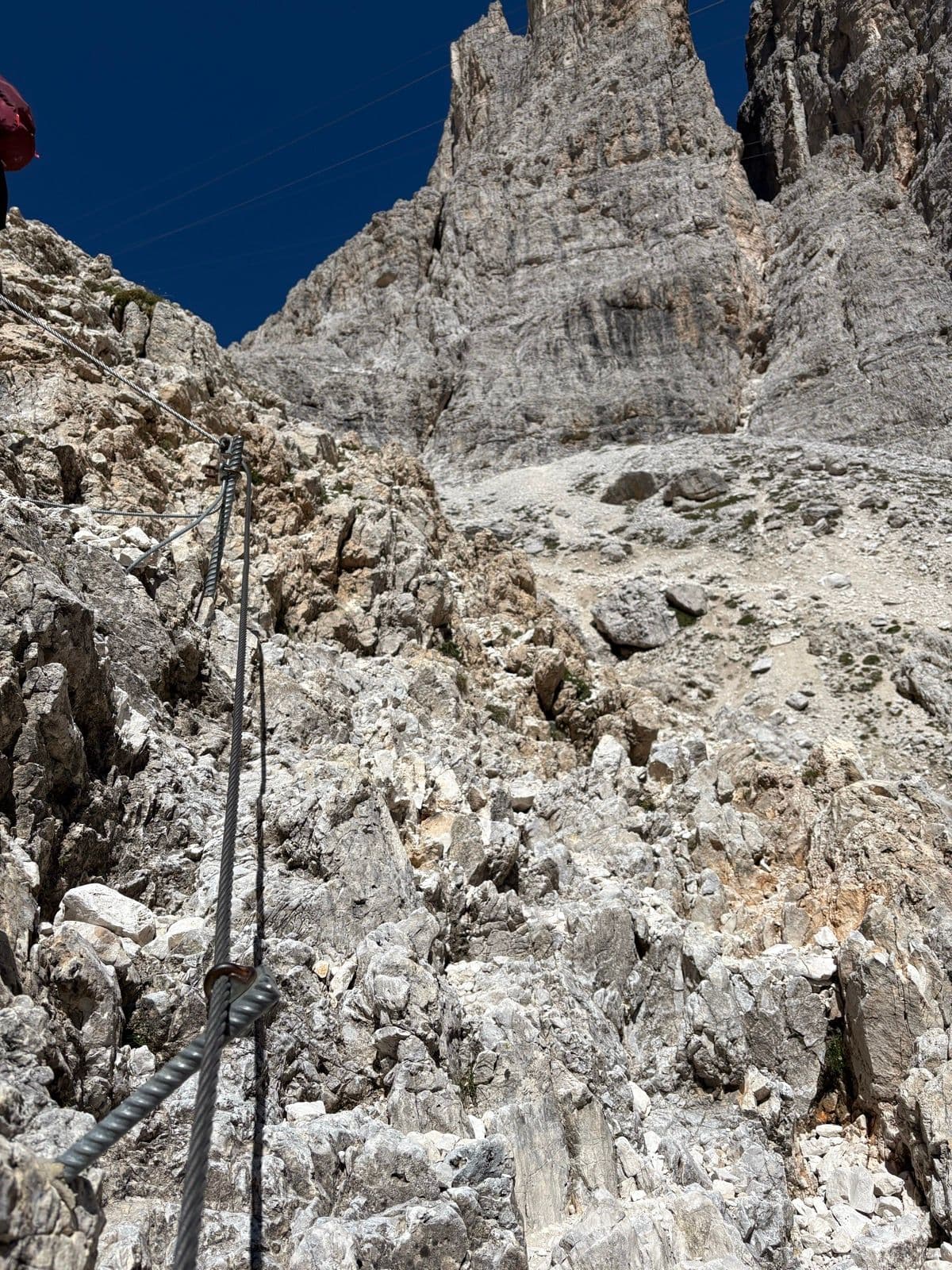Via ferrata cable on a steep, rocky mountain path in the Rosengarten group, Dolomites.