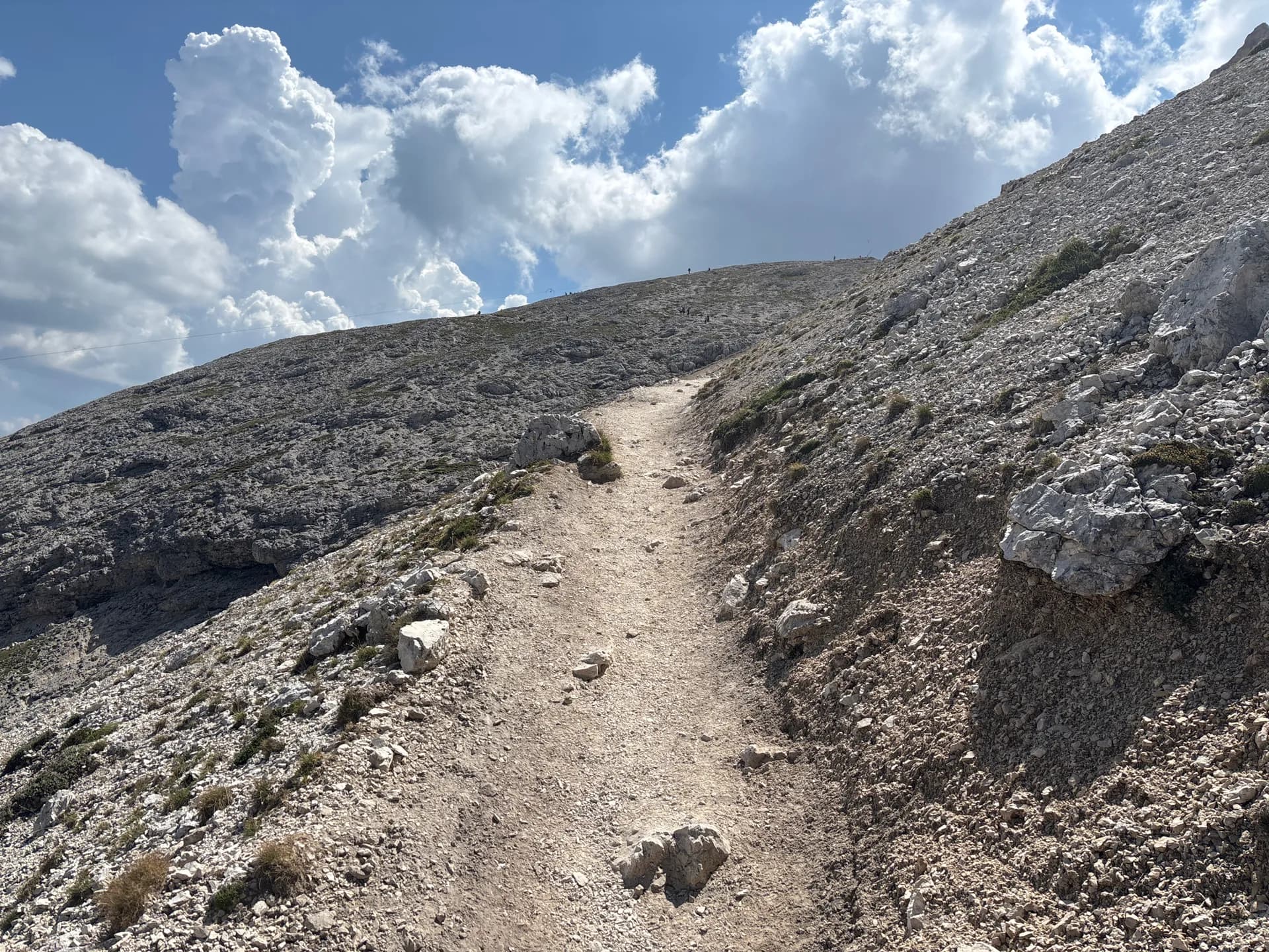 Hiking trail on rocky mountain slopes in the Seiser Alm and Rosengarten area of the Dolomites.