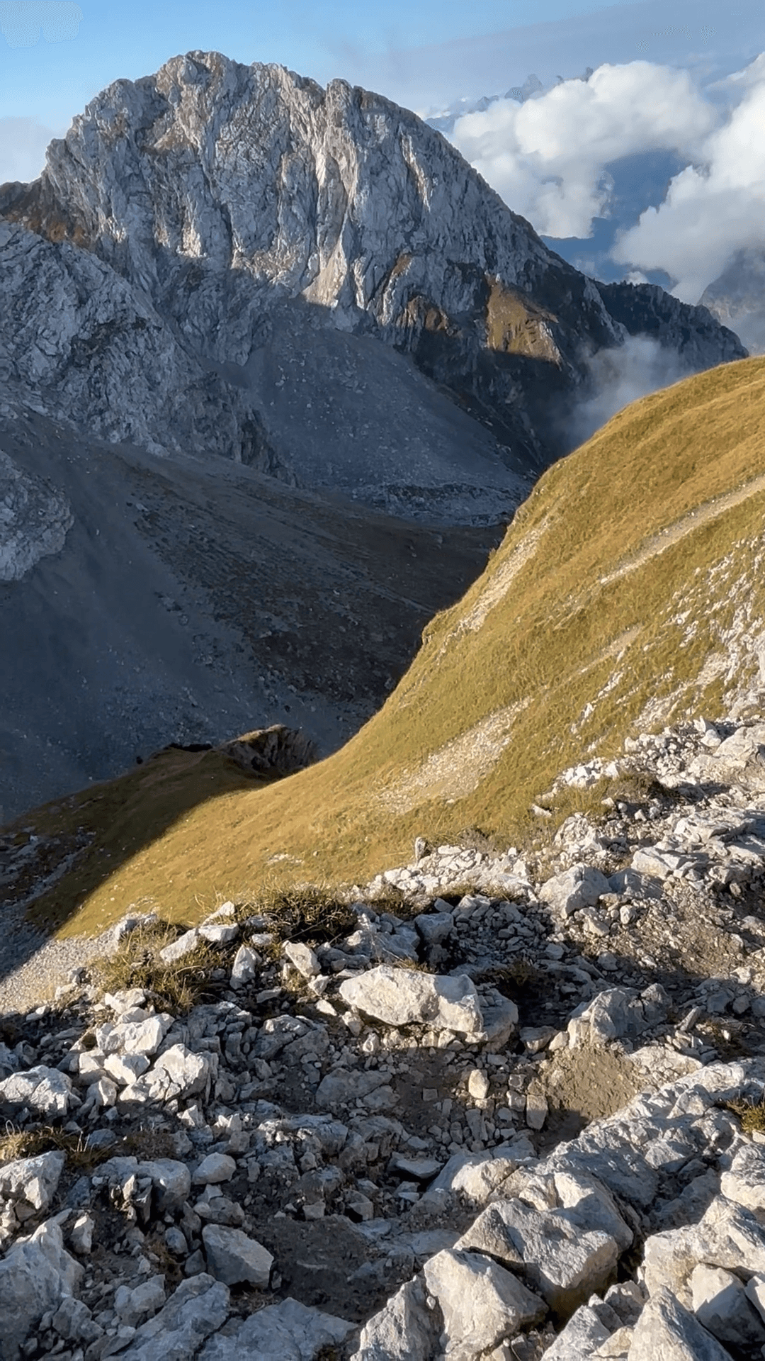 Rocky mountain trail with steep peaks and valley below