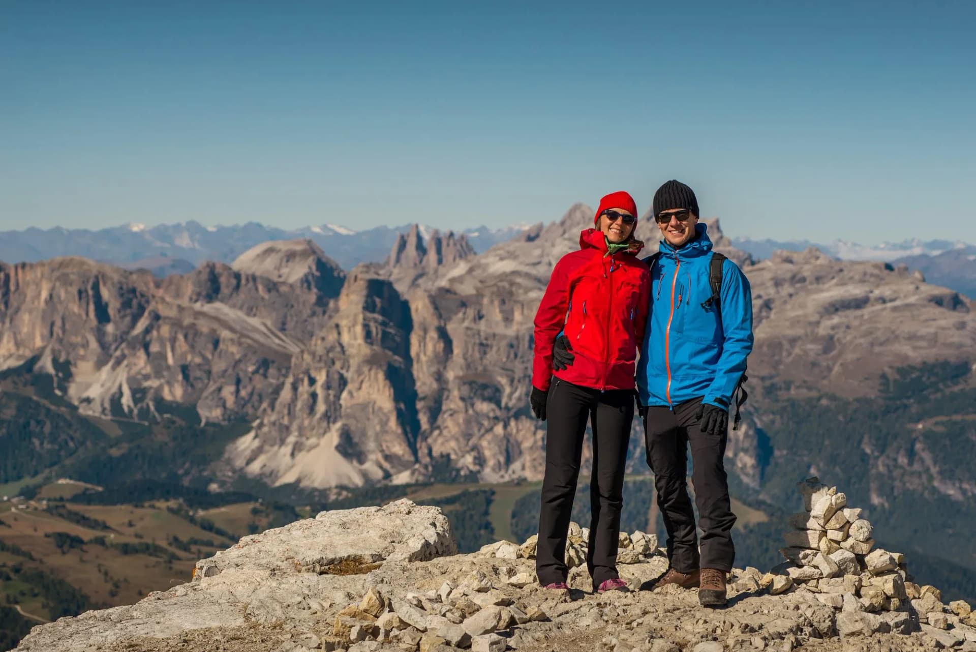 Hikers posing on rocky summit with Lagazuoi mountains in background