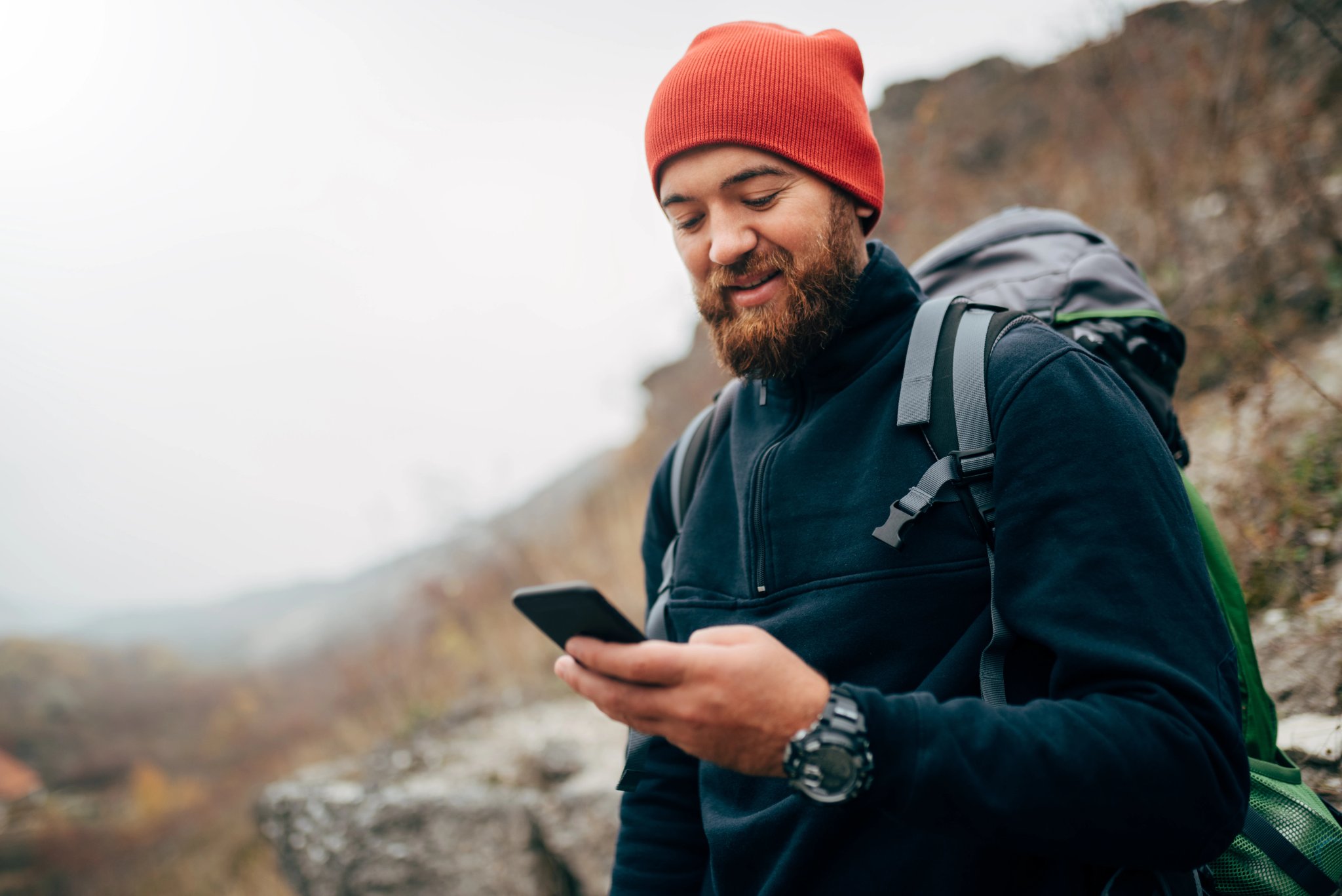 hiker navigating mountains with phone