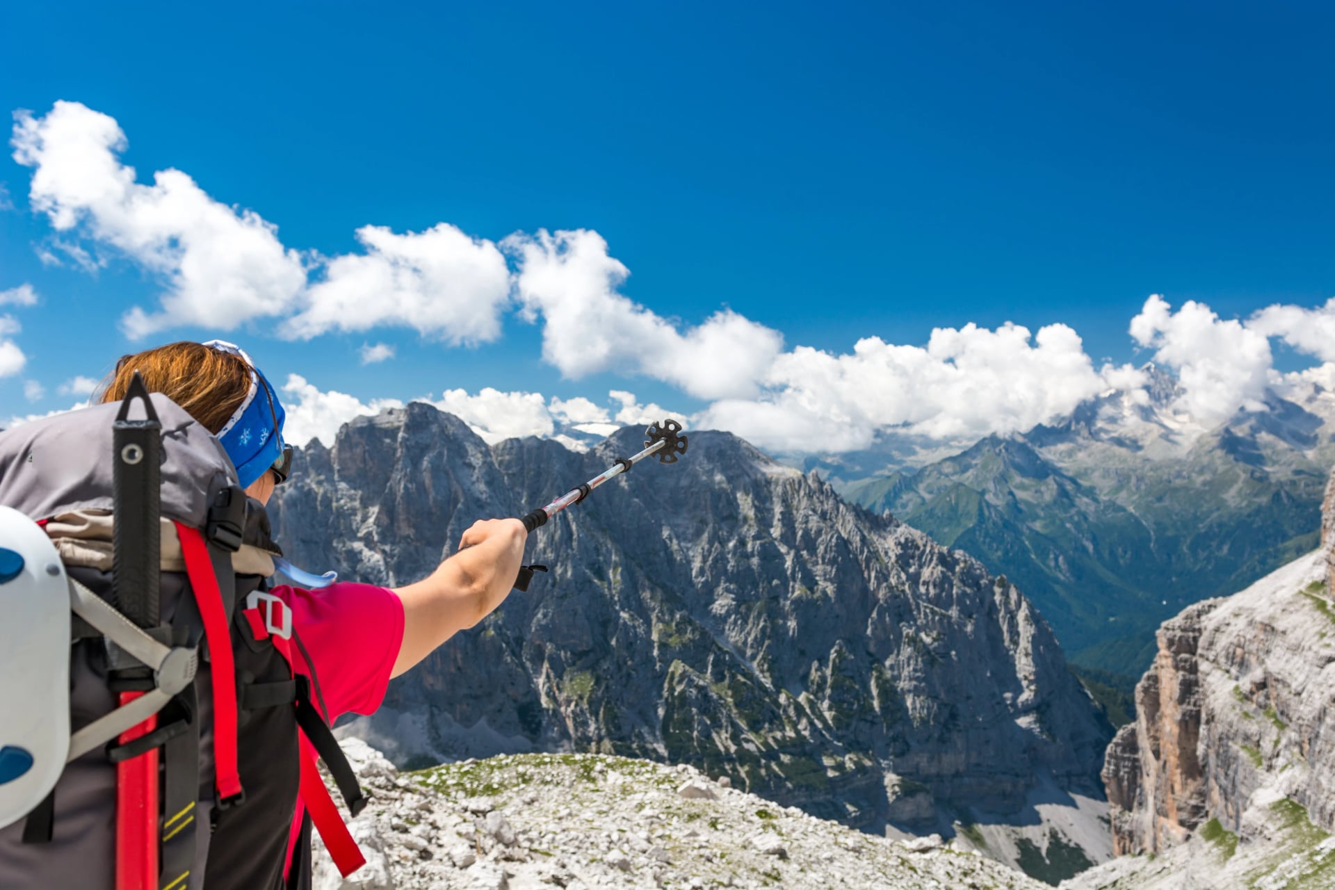 Female climber pointing towards next challenge.