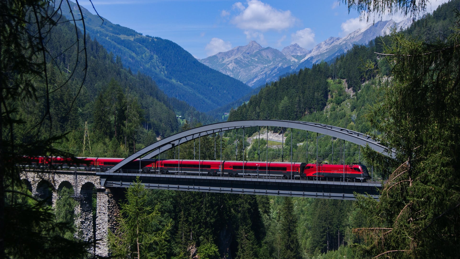 Railjet express crossing river Trissnana near to city names Landeck in austrian alps.