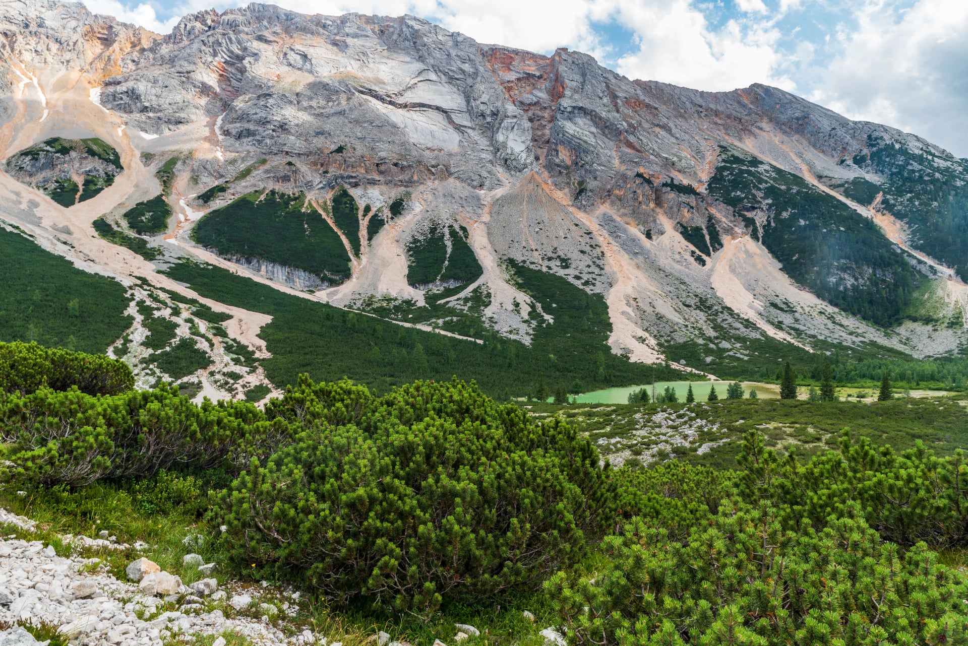 Lago Piciodel lake with rocky peak above in Fanes valley in Dolomites
