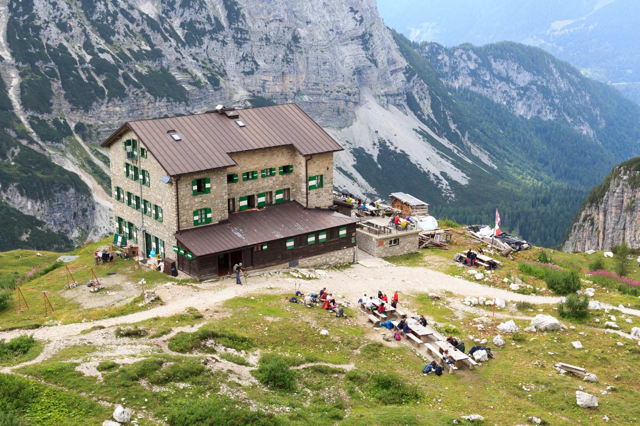 Alpine hut Rifugio Brentei and mountain alps panorama in Brenta Dolomites, Italy