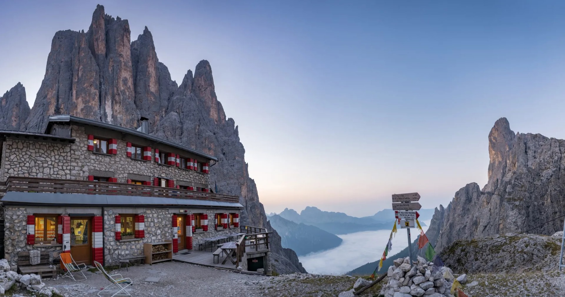 Pradidali Rifugio at Pale di San Martino in the Dolomites above a sea of clouds.