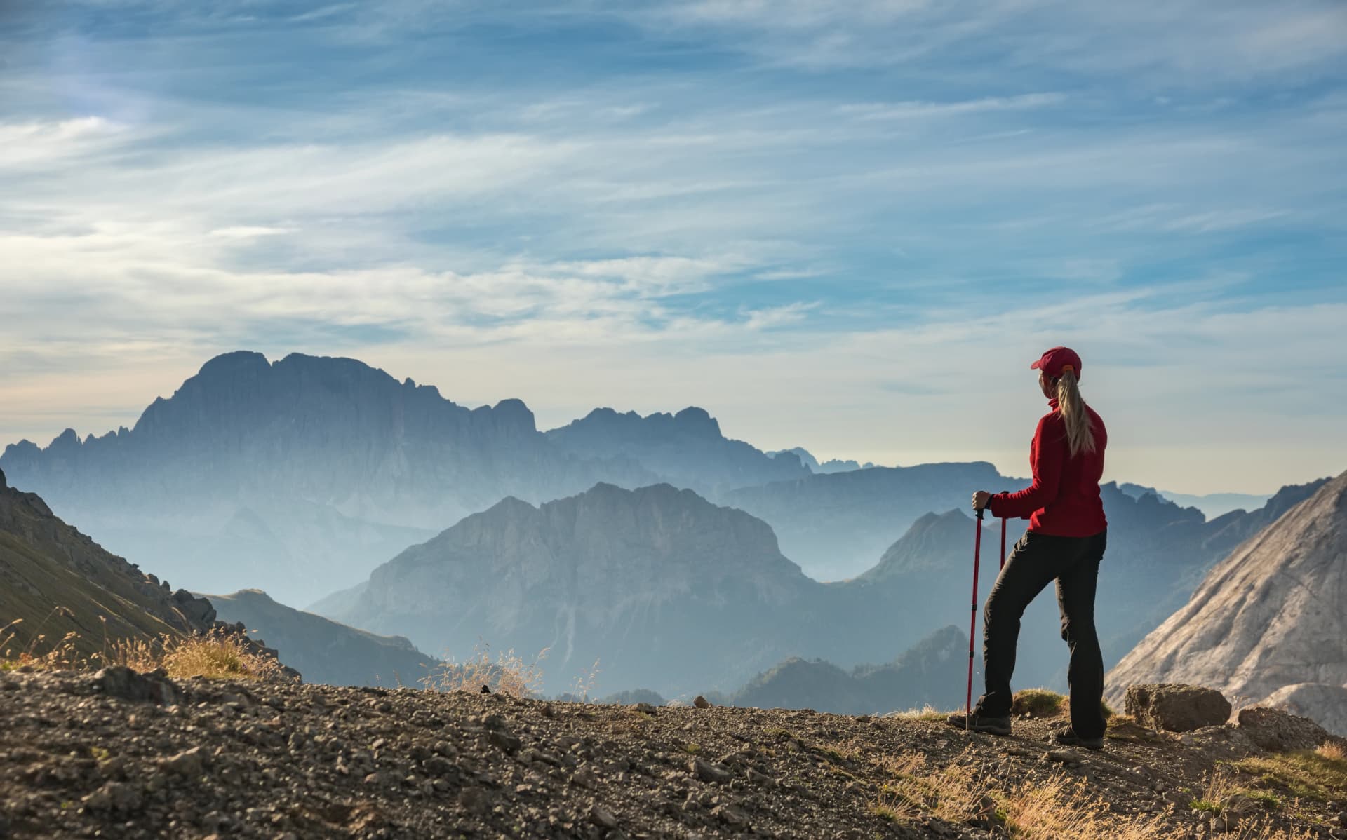 Sporty Young woman on mountain trail Dolomites Mountains, Italy
