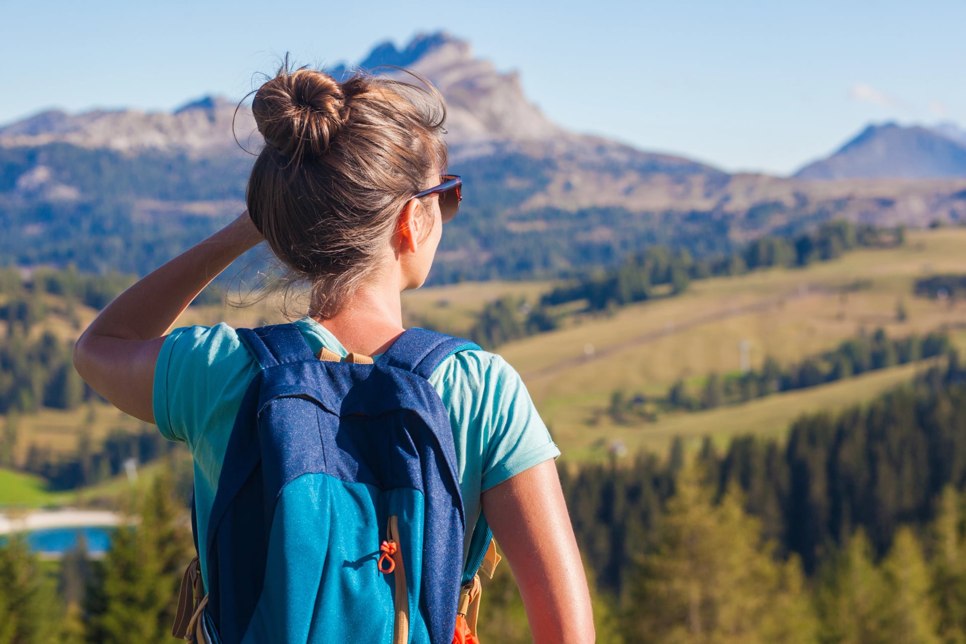 Young smiling woman hiking at Pralongia. Alta Badia, Dolomites, Italy