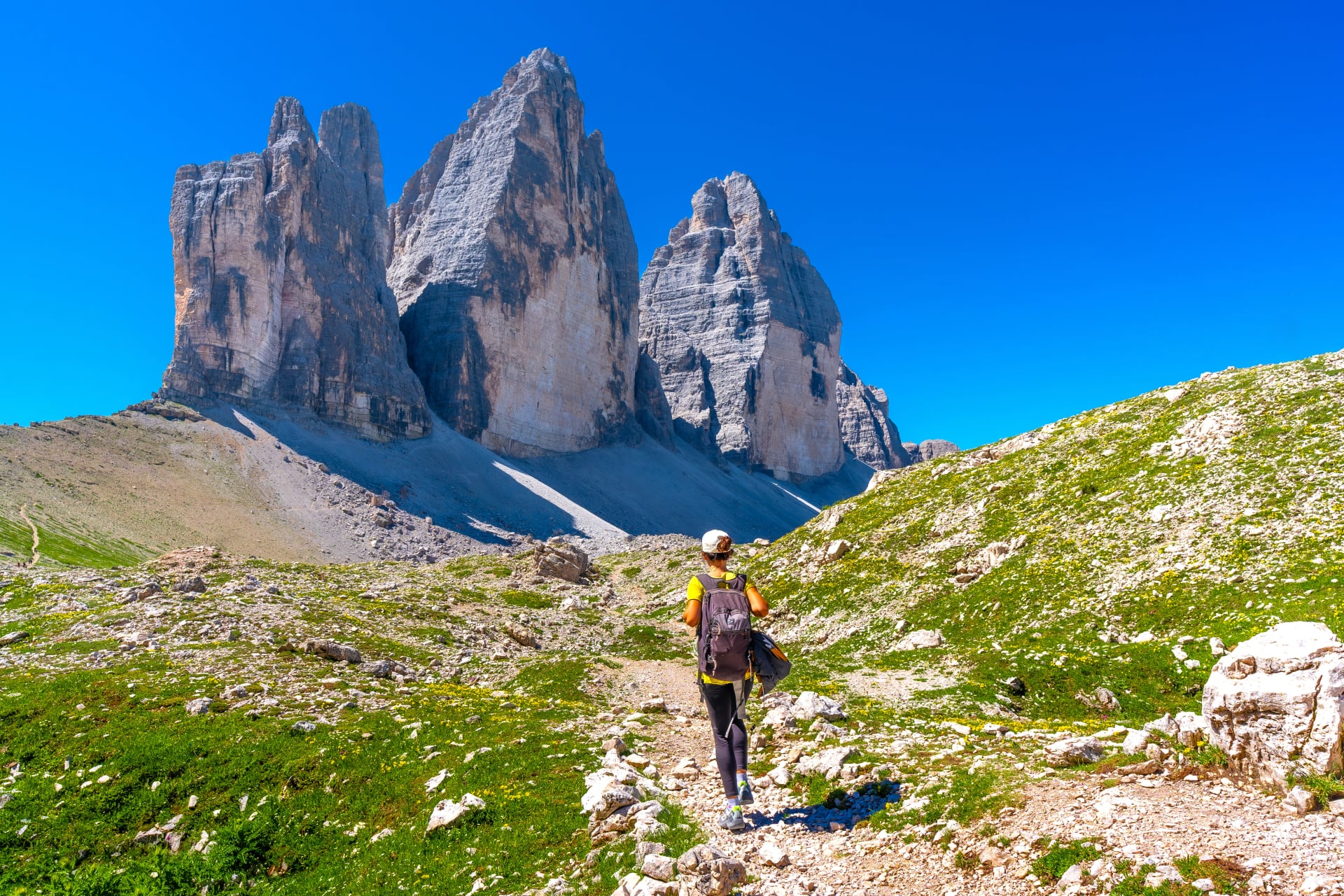 Tourist hiking on the tre cime lavaredo trail in the italian dolomites