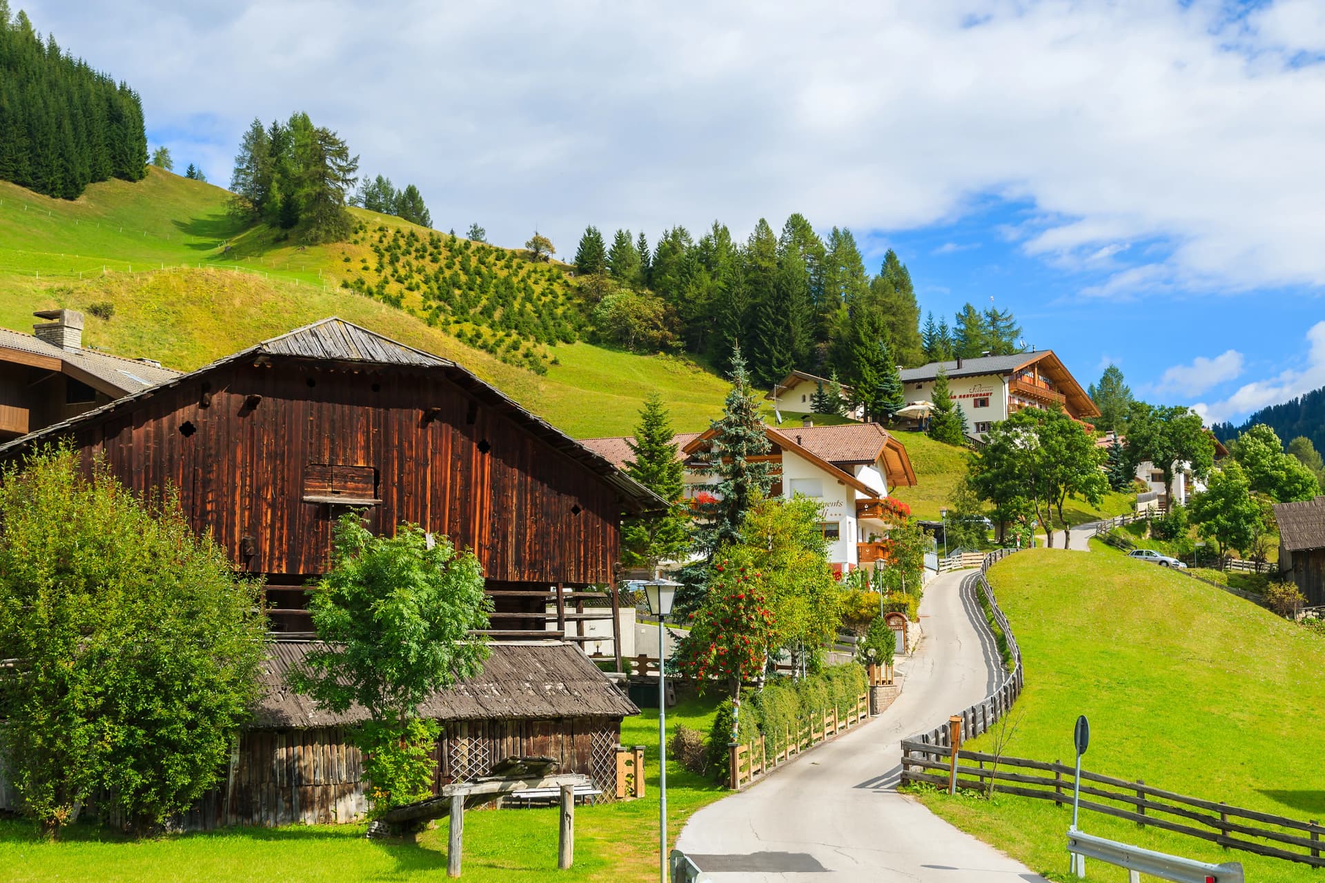 Street in Colfosco alpine village, Dolomites Mountains, Italy