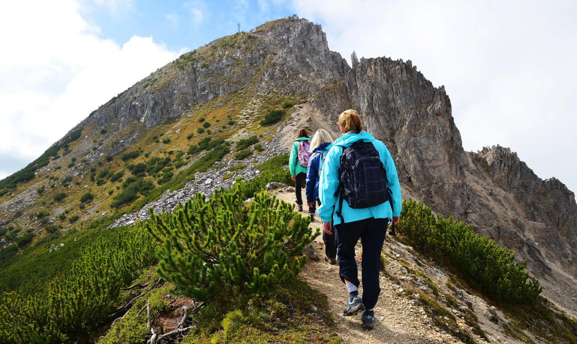 Tourists on a trip in Dolomites mountain , Val di Fiemme, South Tyrol, Italy.