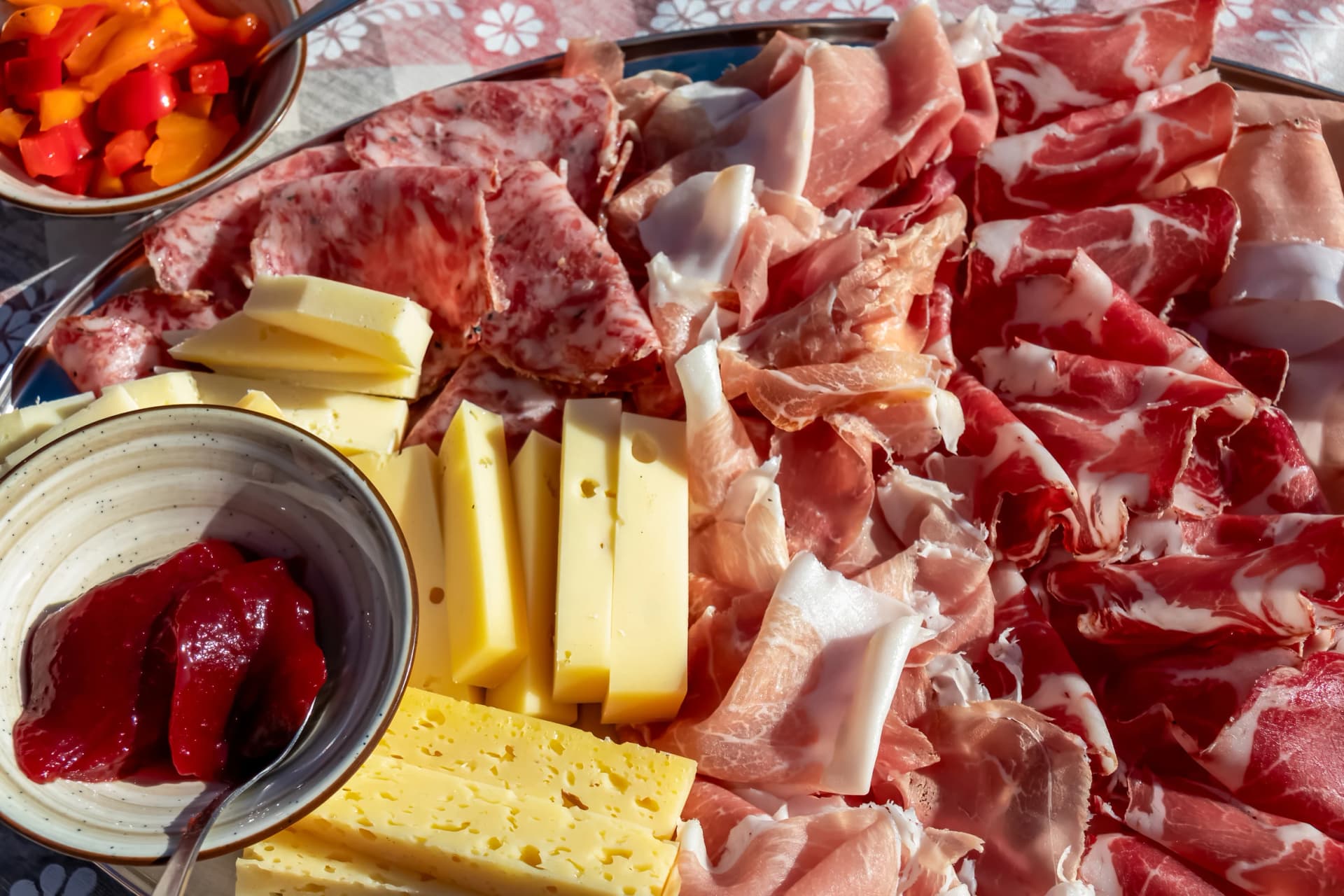 Typical meat plate served in traditional mountain cottage in Carnic Alps, Friuli Venezia Giulia, Veneto, Italy, Europe. Local Sauris prosciutto crudo, ham, cheese. Appetizer dish in Alpe Adria region