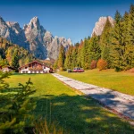 Adorable autumn view of small hottel on Pradidali valley, Province of Trento, Italy, Europe. Gorgeous morning scene of Dolomite Alps. Beauty of countryside concept background.